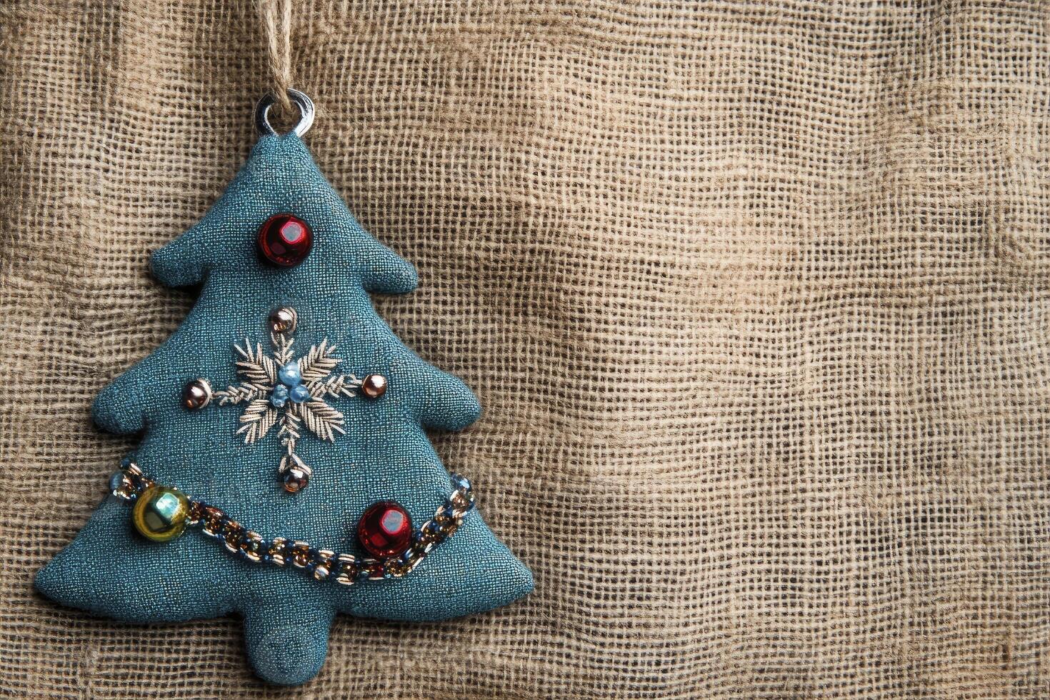 Christmas Tree Ornament Hanging on Burlap Background for Holiday Decor photo