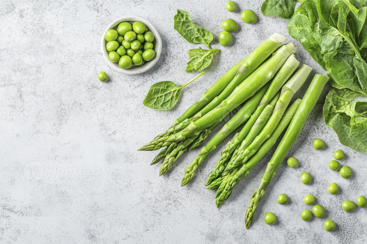 Asparagus with Green Peas and Spinach on Grey Surface Still Life photo