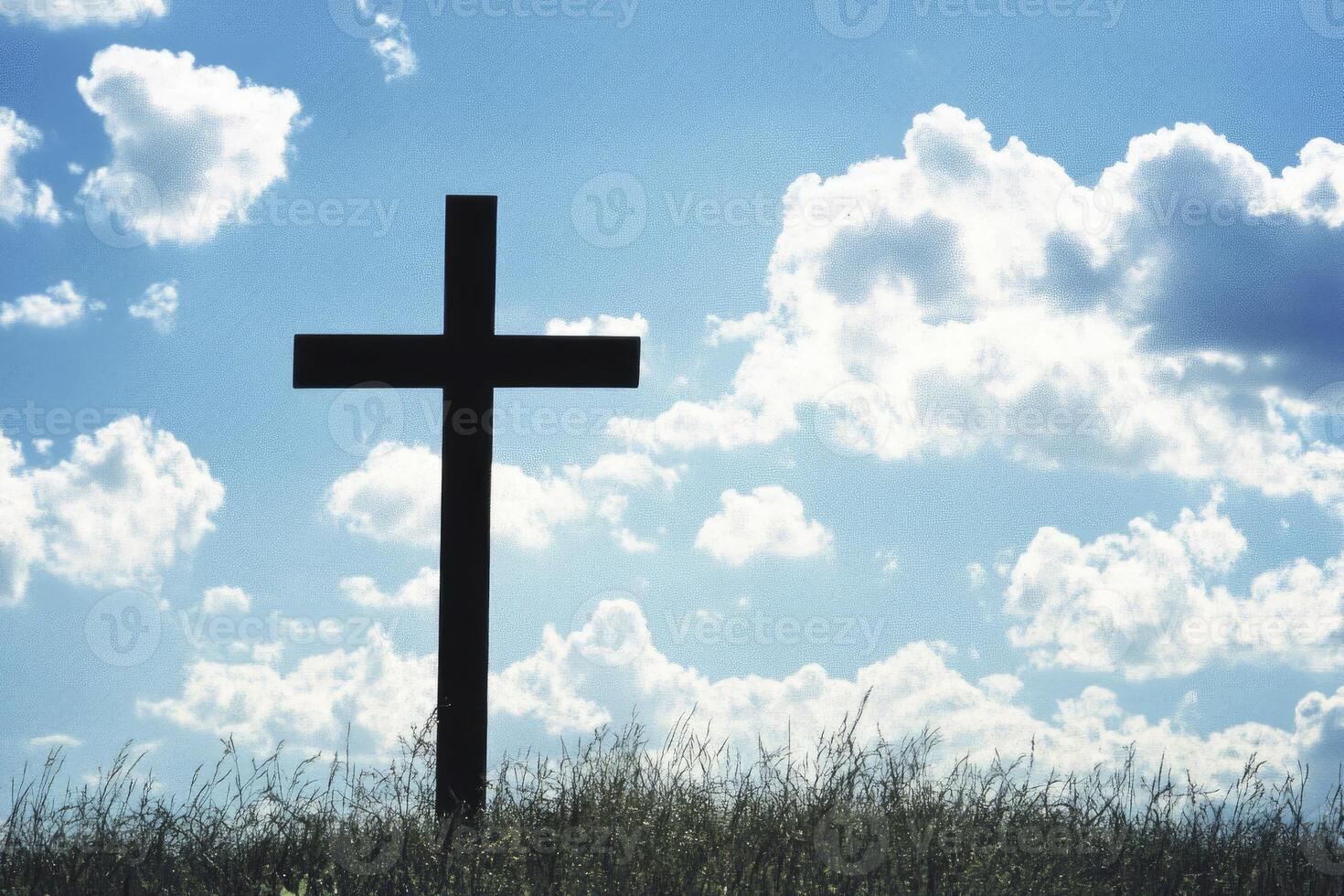 Silhouette of Christian Cross on Grassy Hill with Cloudy Blue Sky photo