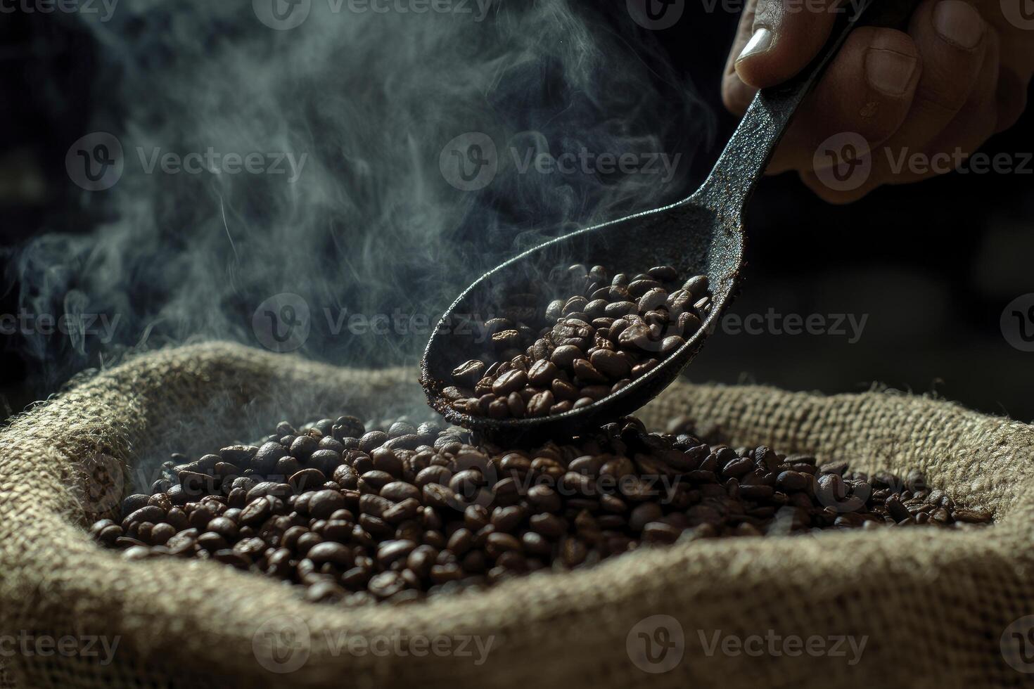 Steaming Roasted Coffee Beans in Burlap Sack with Hand Holding Spoon photo