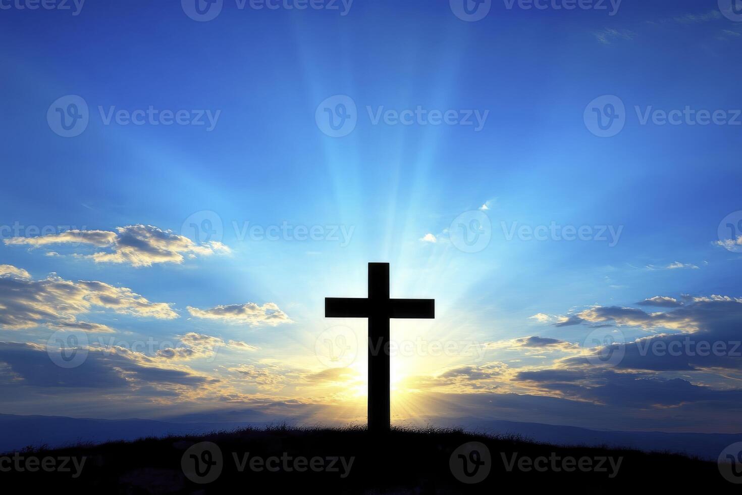 Silhouette of Cross at Sunset Against a Bright Blue Sky Background photo
