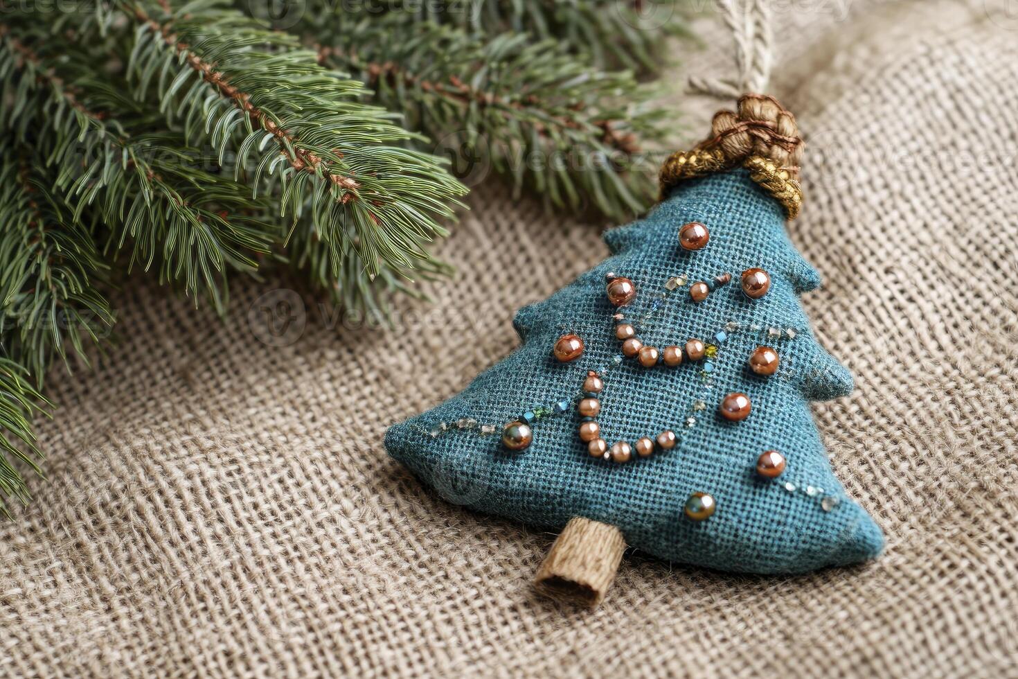Handmade Christmas Tree Ornament with Evergreen Branch on Burlap Fabric photo
