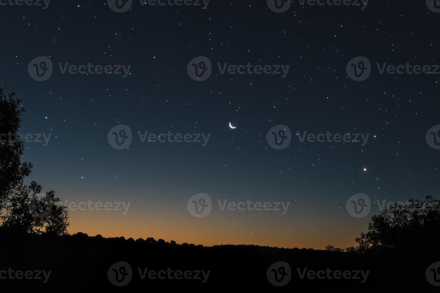 Crescent Moon and Stars Over a Silhouette Landscape at Dusk photo