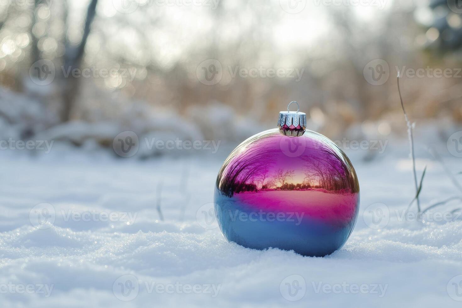 Holiday Ornament Reflecting Winter Trees Laying in Fresh Snow Outdoors photo