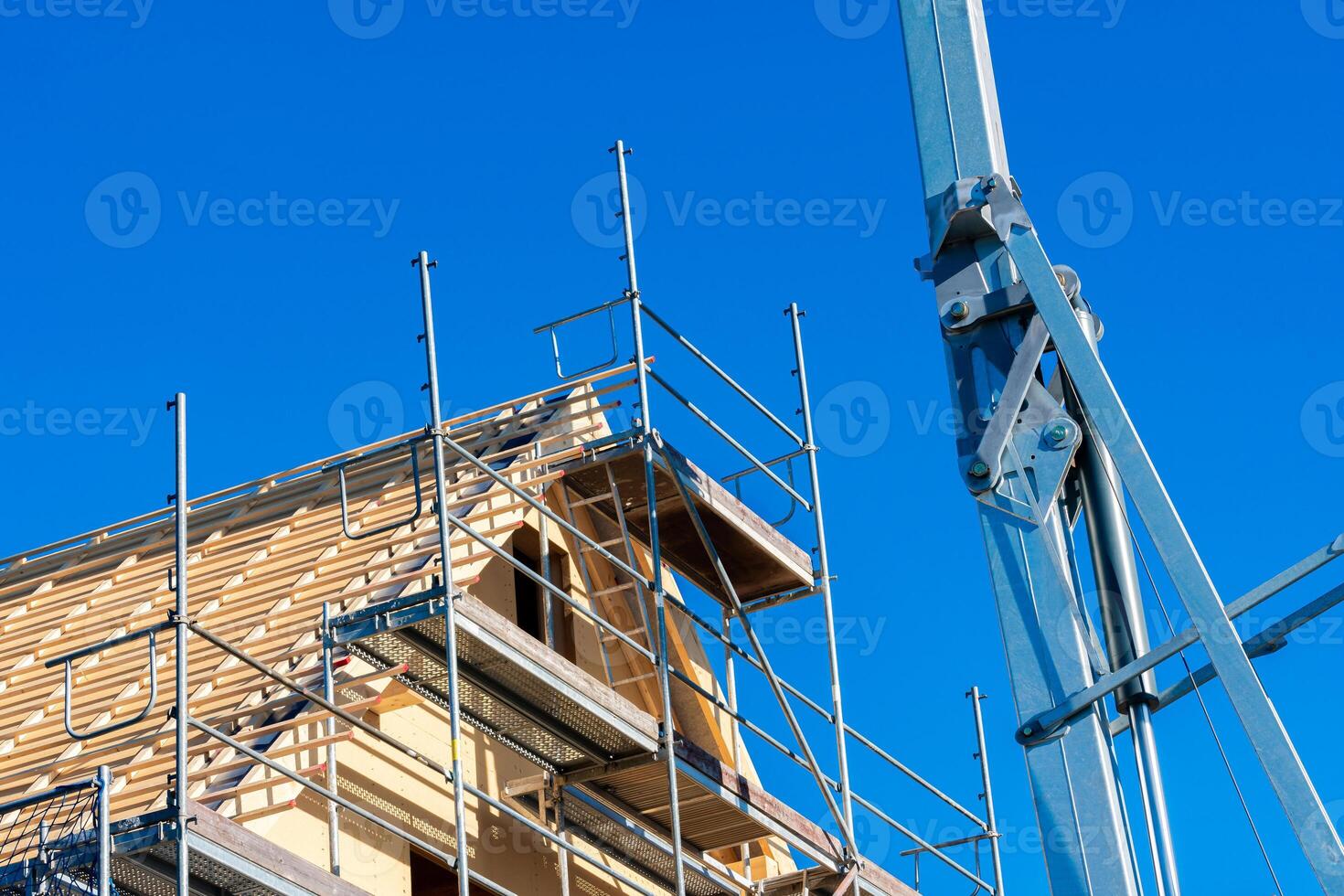Work continues on a building under construction, featuring scaffolding photo