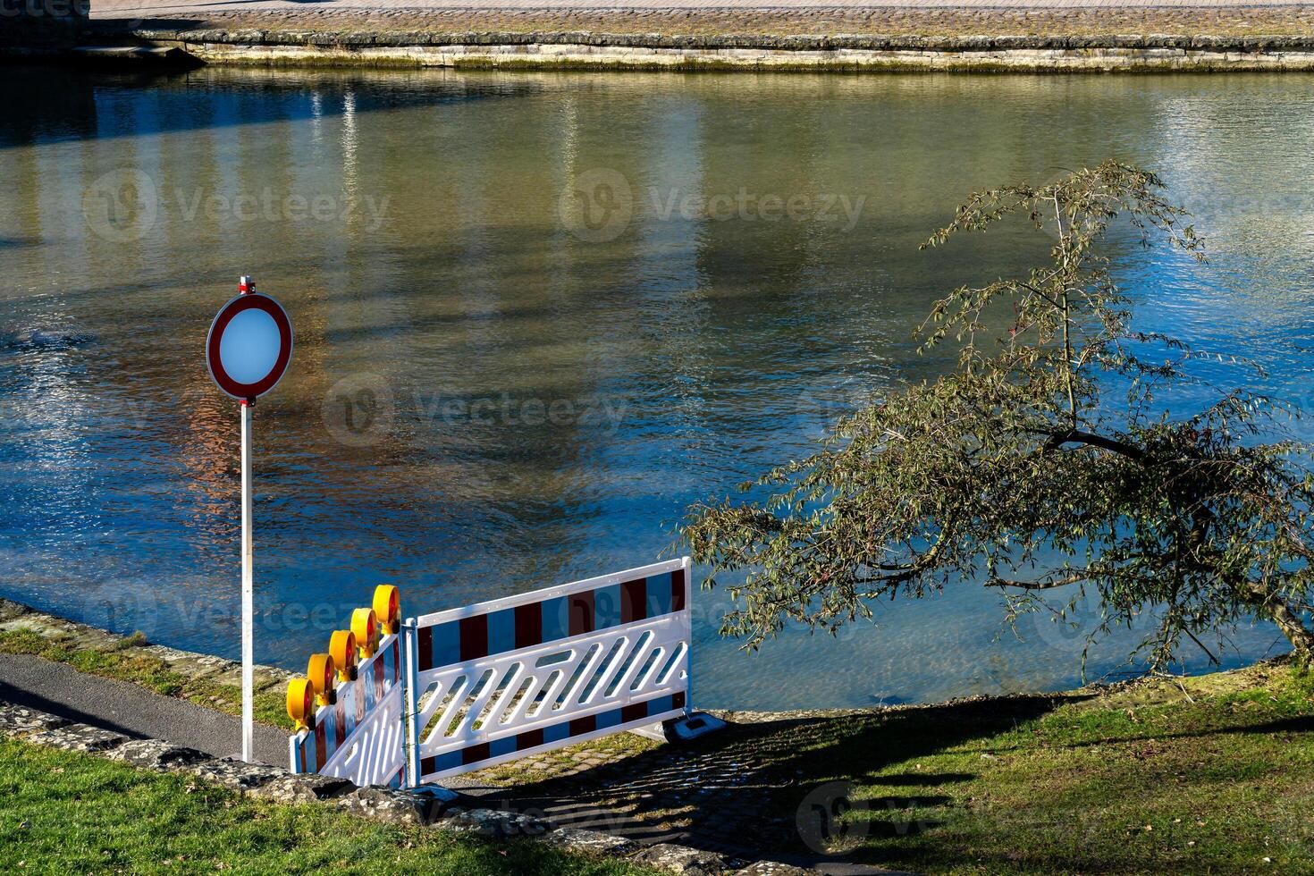 A barrier and warning sign mark restricted access along the serene photo