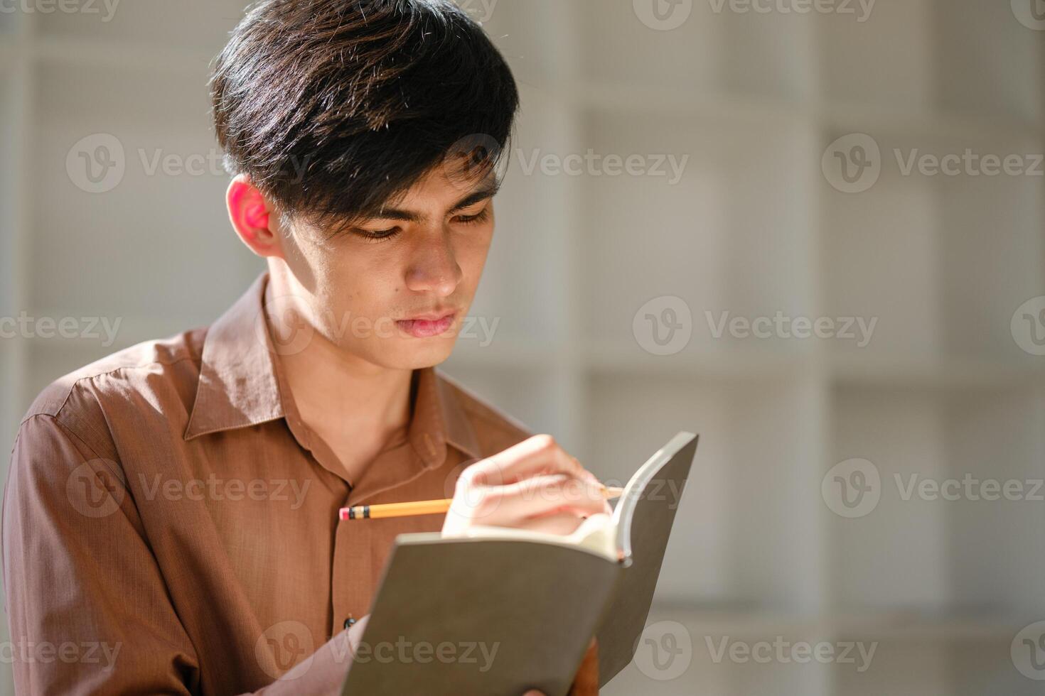 Young man studying online researching financial concepts for education and career development photo