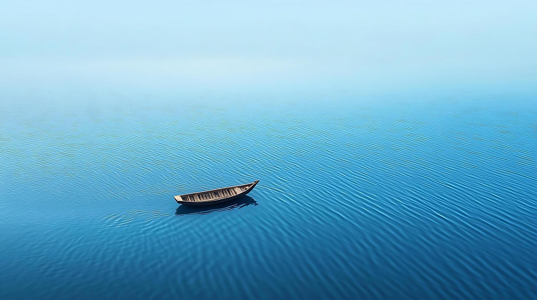 A boat floating in the middle of a blue ocean photo