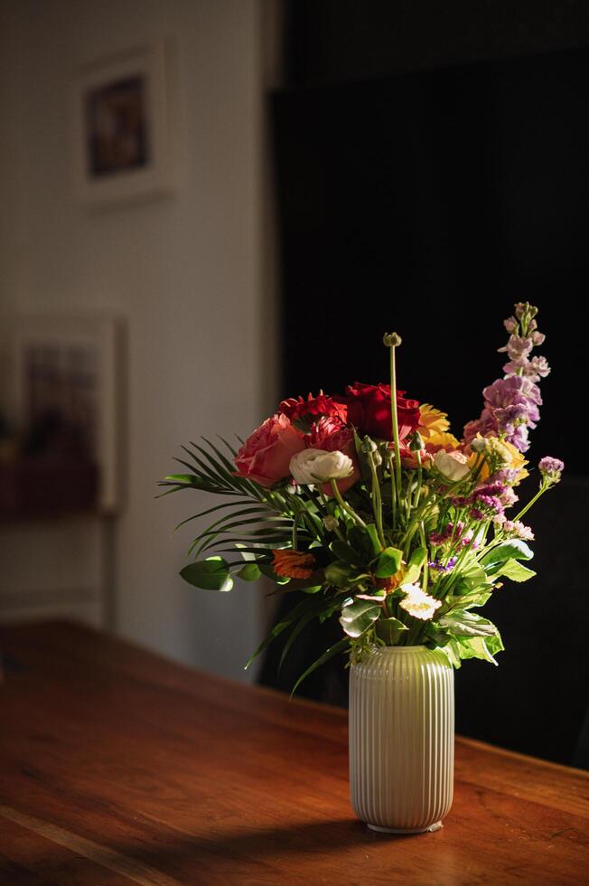 A serene interior scene with a bouquet of wildflowers catching the first rays of the day. photo