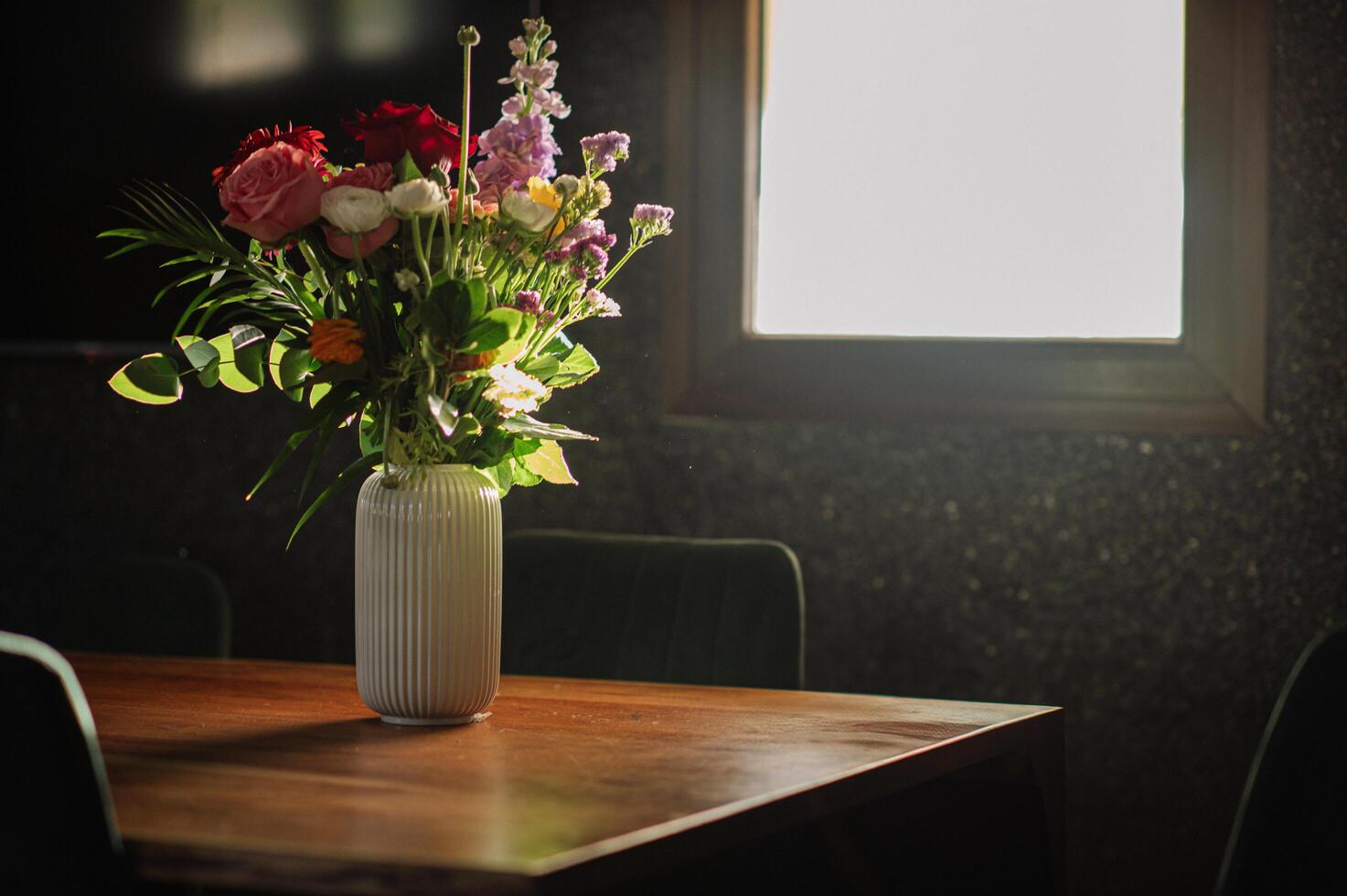 A charming bouquet in a glass vase brings warmth and elegance to the cozy morning atmosphere. photo