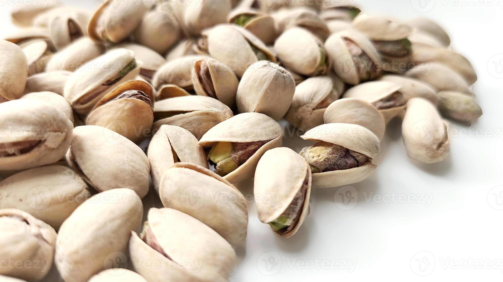 background with pistachio nuts. Nuts rich in vitamins and microelements are ready to eat. Vegetarian food photo