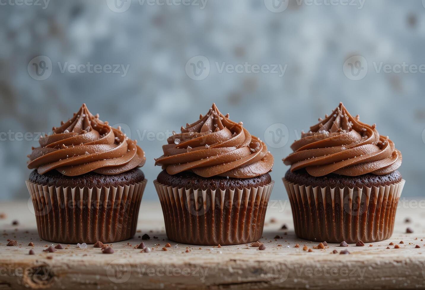 Three cupcakes with chocolate. photo