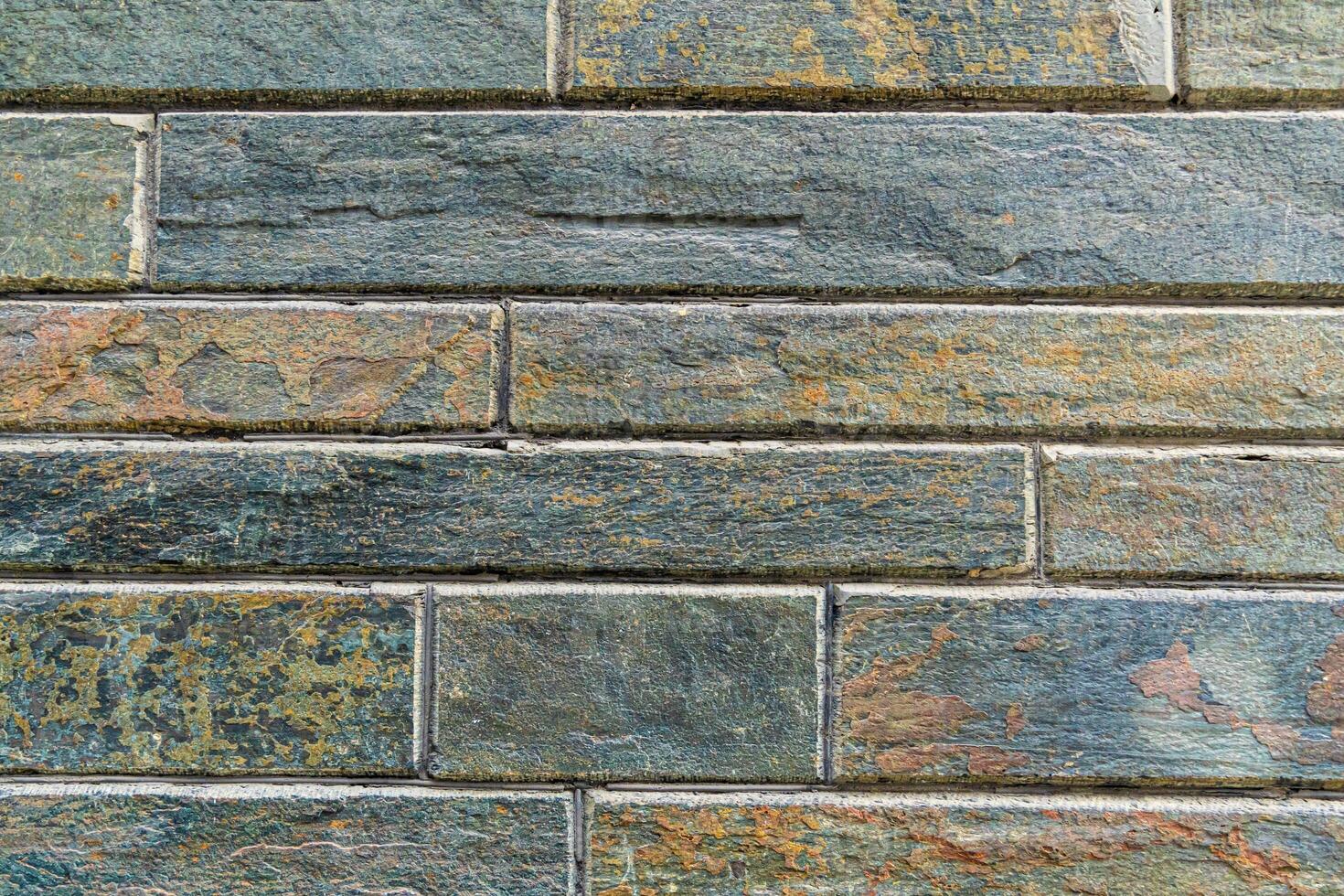 A seamless brick wall texture in shades of dark green and black. This high-resolution image is perfect for use as a background for websites, presentations, or print projects. photo