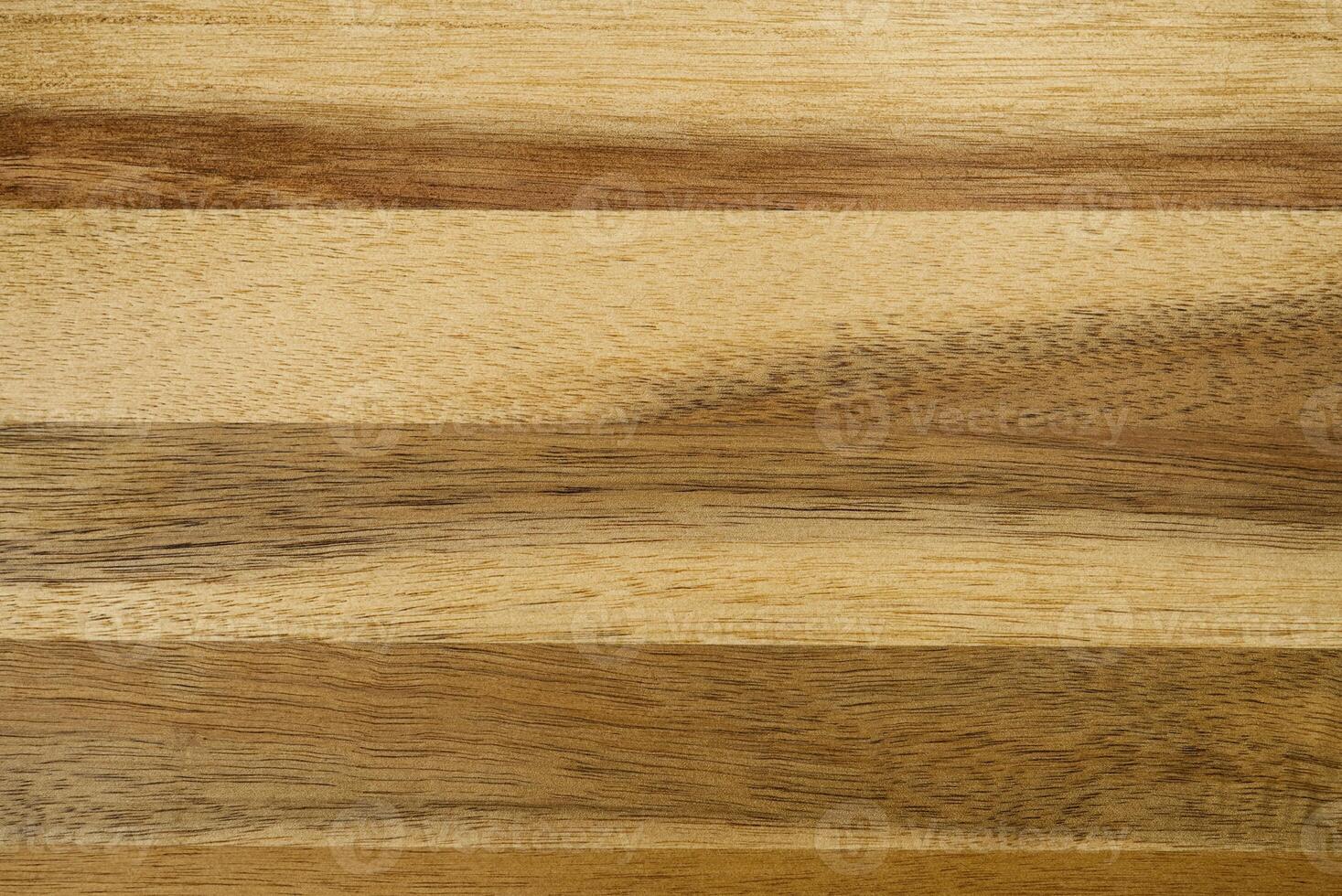 This image showcases a close-up of a textured light brown wood grain background with horizontal planks and natural stripes, perfect for design projects needing a rustic or organic touch. photo
