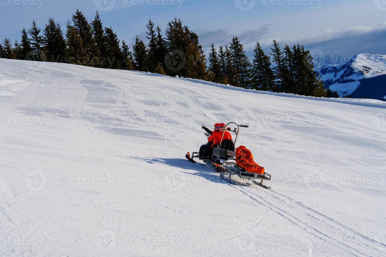 A person with a disability is joyfully enjoying the stunning winter landscape while skillfully riding a snowmobile through the deep snow, embracing adventure and freedom in the great outdoors. photo