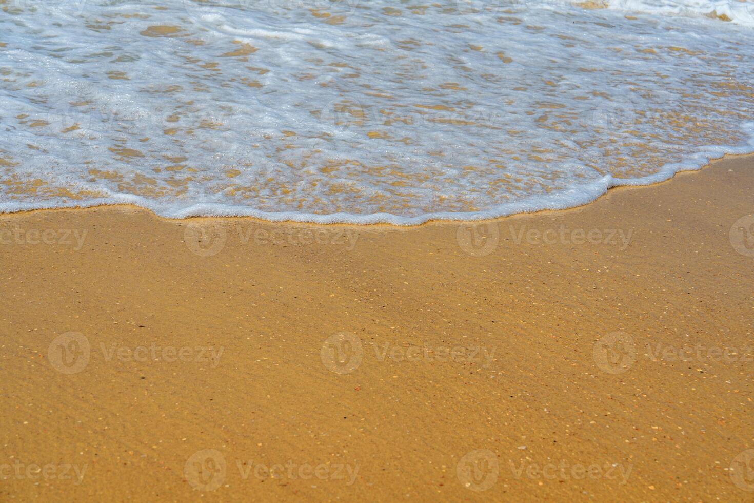 A sandy beach with gentle waves lapping at the shore can be a relaxing and peaceful place. This image is perfect for stock agencies and can be used in a variety of projects. photo