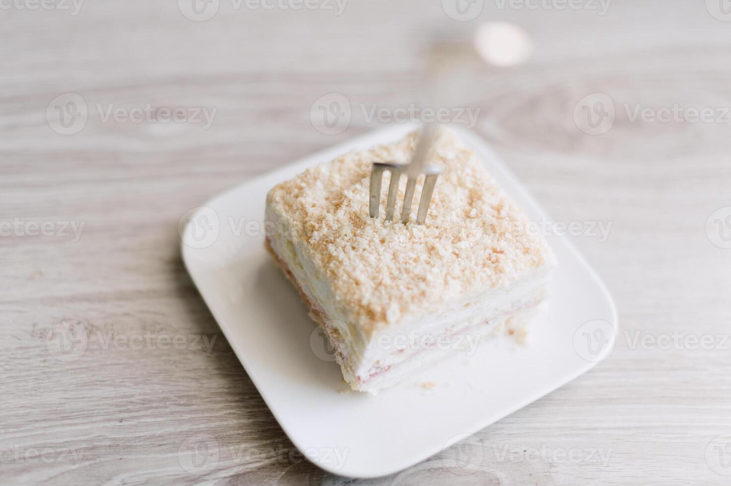 A fork is on a plate with a piece of cake photo