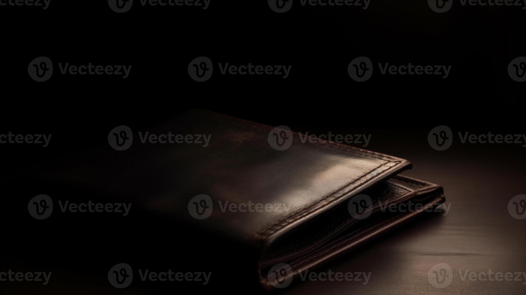 A leather wallet is laying on a table photo