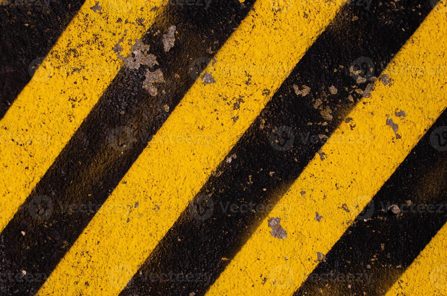 Grunge yellow and black diagonal stripes. Industrial warning background, warn caution, construction. photo