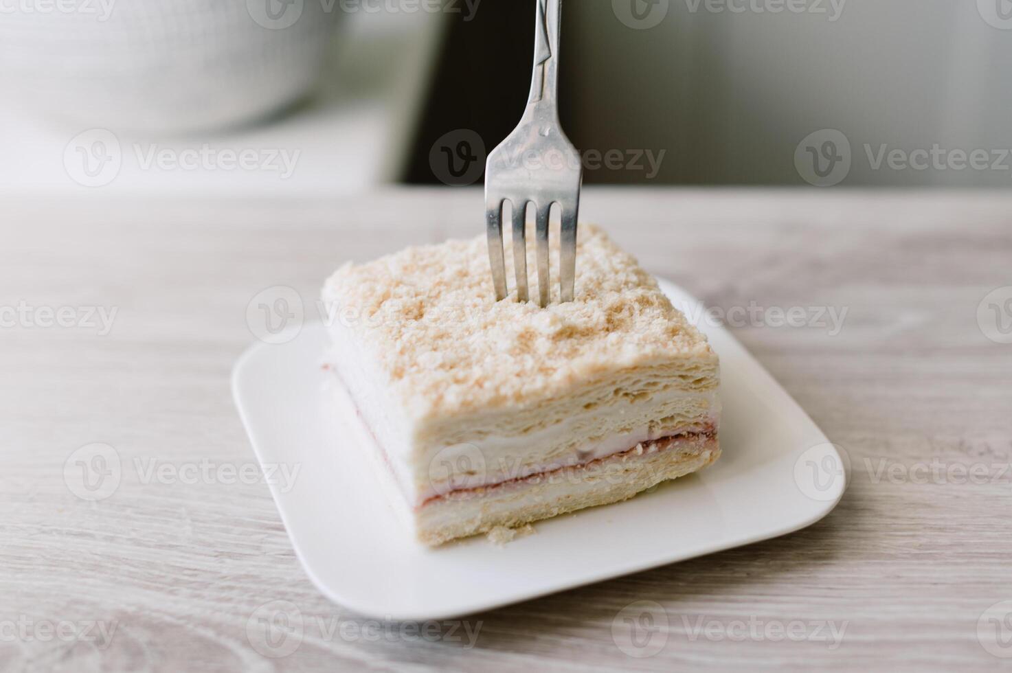 A fork is being used to eat a piece of cake photo