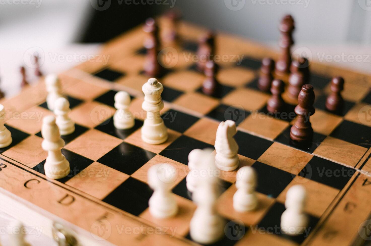 A wooden chess board with a few pieces on it photo