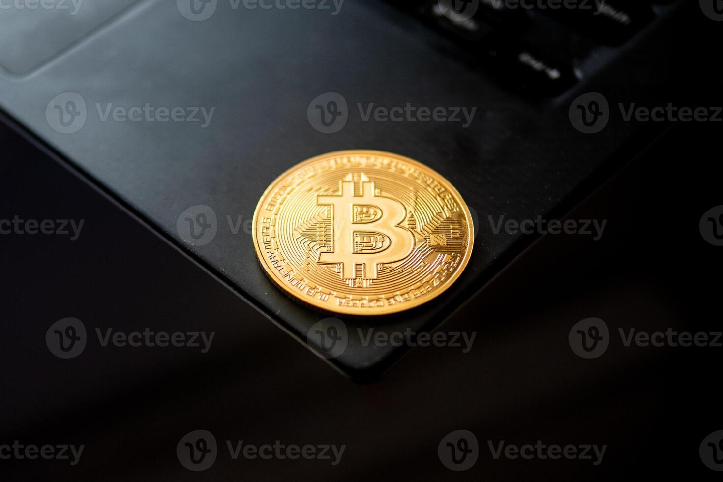 A gold coin with the Bitcoin on it photo