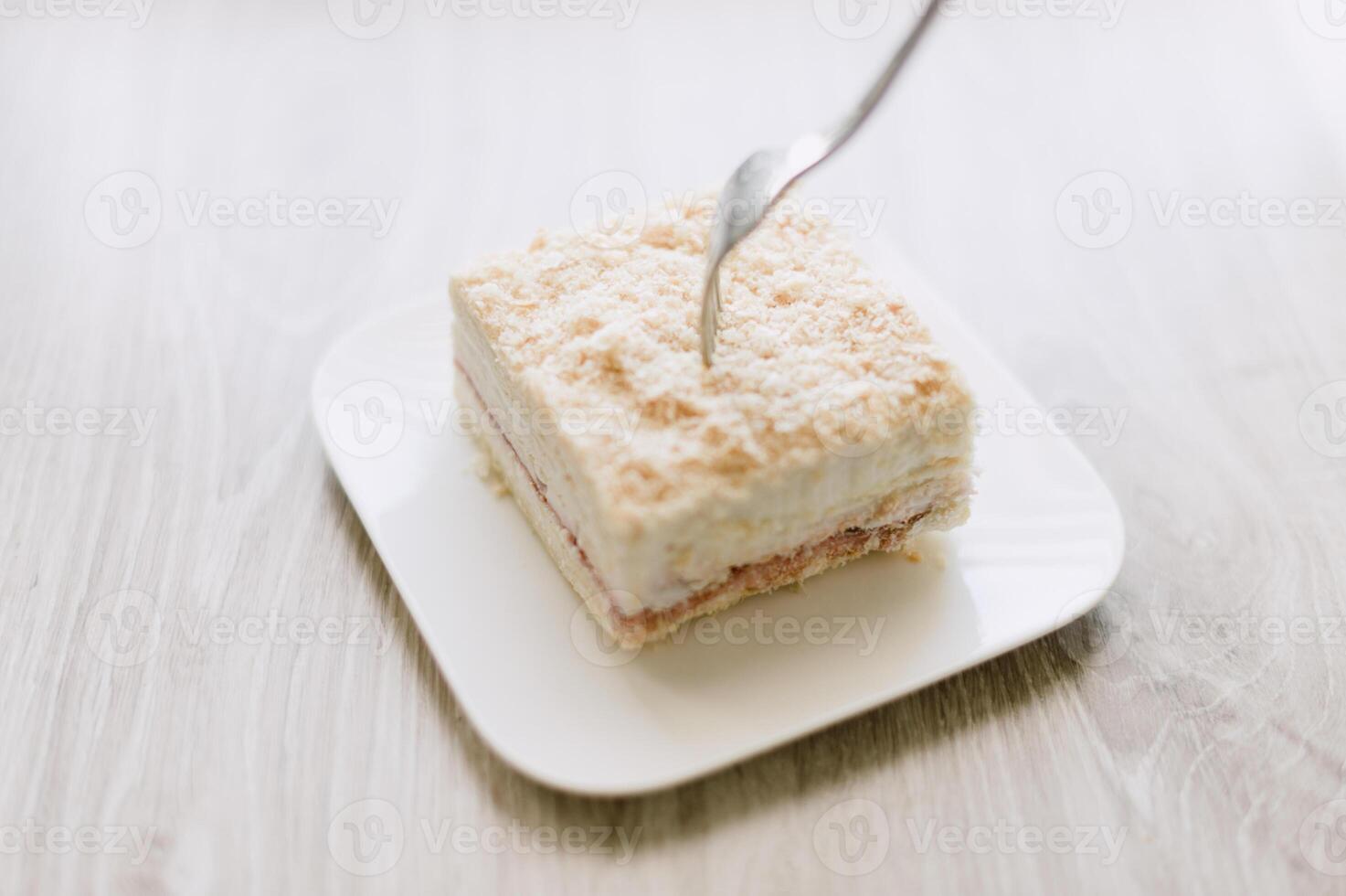 A fork is on a plate with a piece of cake photo