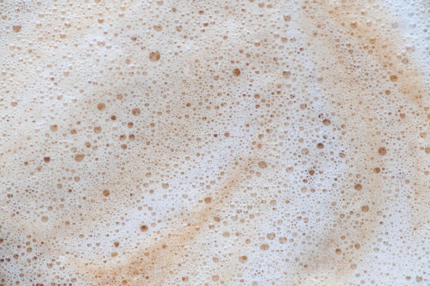A white background with a brown swirl of foam photo