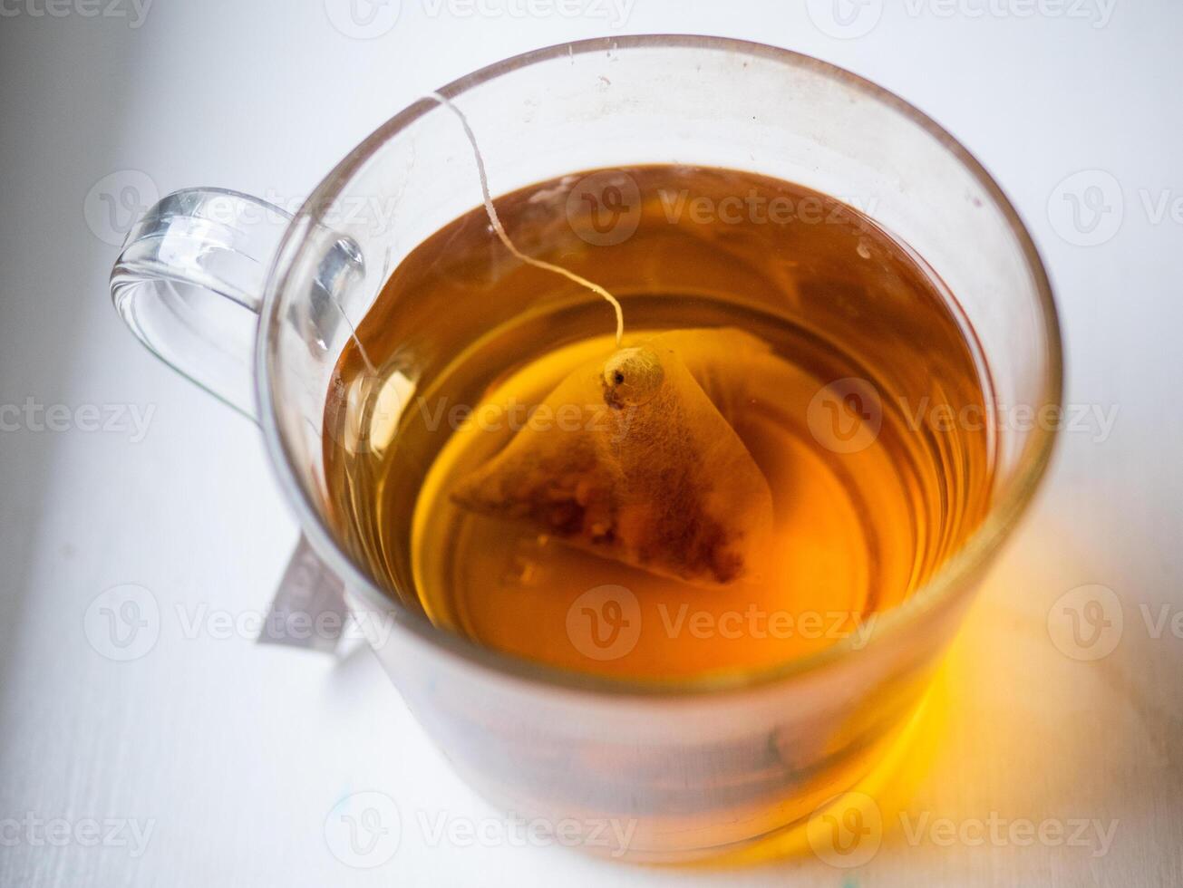 A cup of tea with a tea bag in it photo