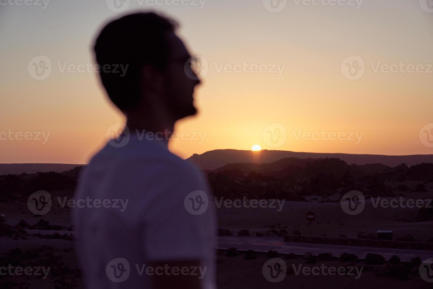 Tourist enjoying sunset in nature photo
