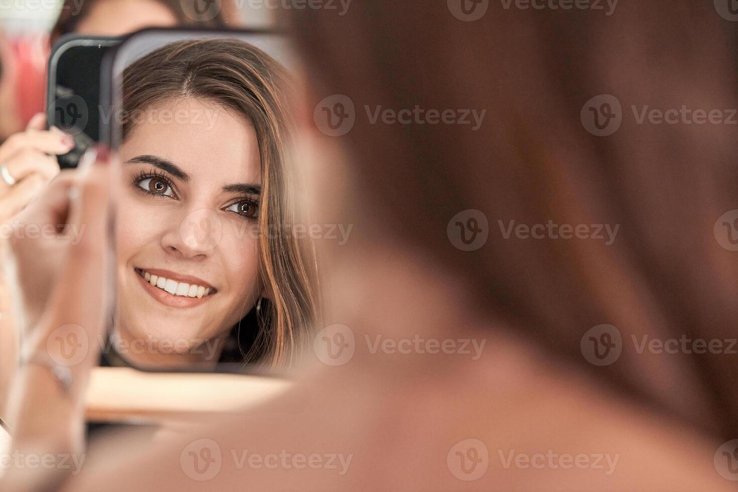 Content woman looking at mirror photo