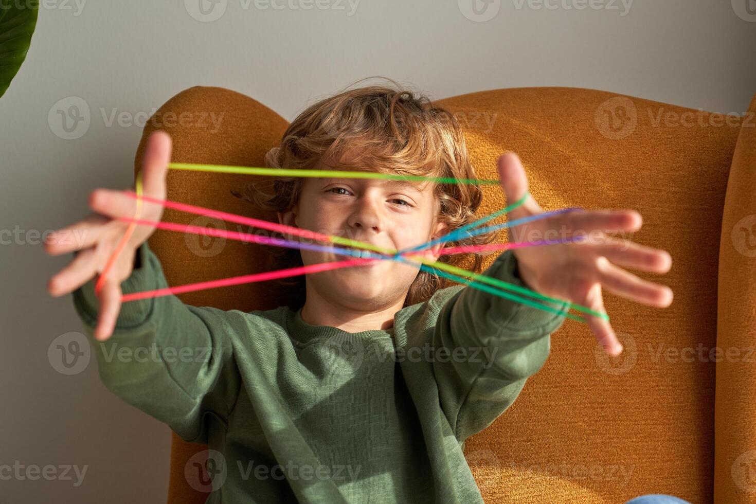 Content boy showing string on fingers photo