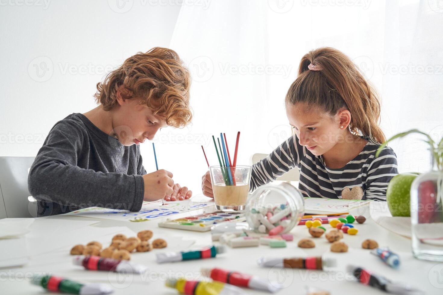 Focused children painting at table photo
