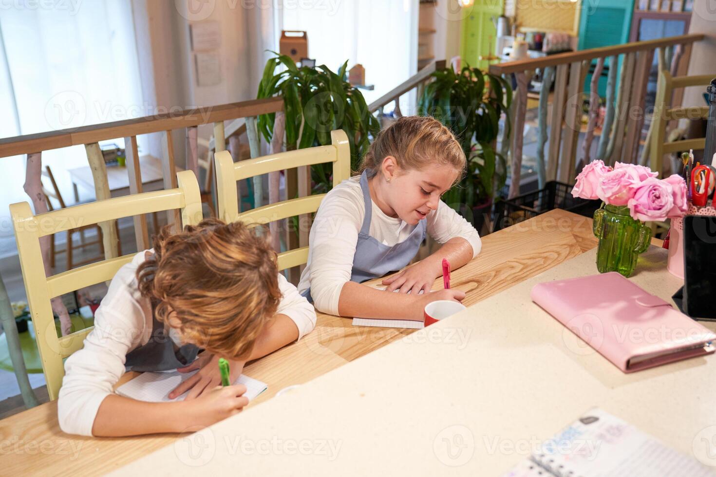 Cute kids painting on papers in creative studio photo
