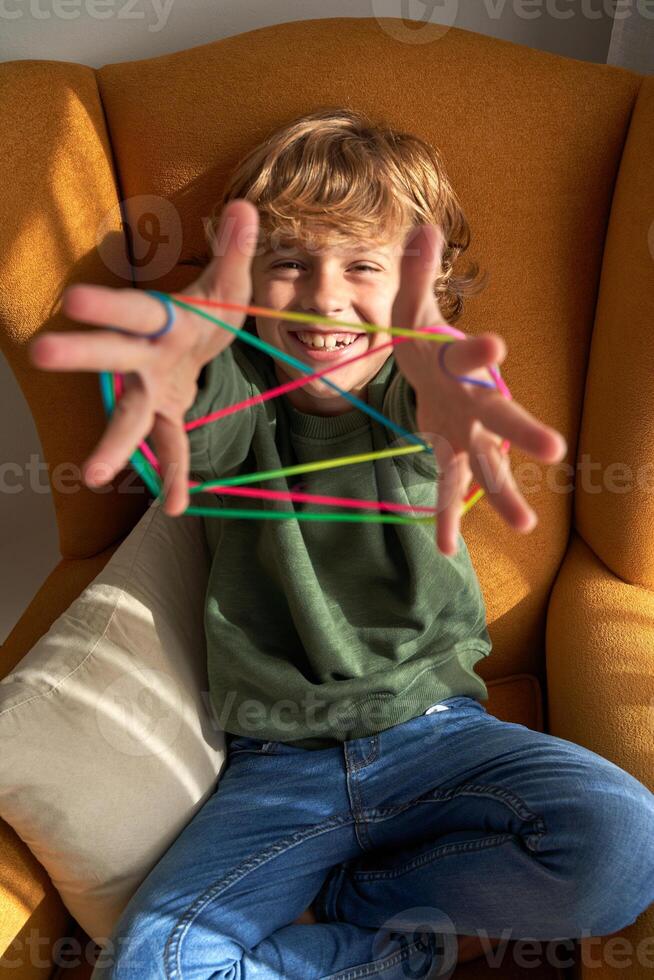 Happy kid enjoying string game at home photo