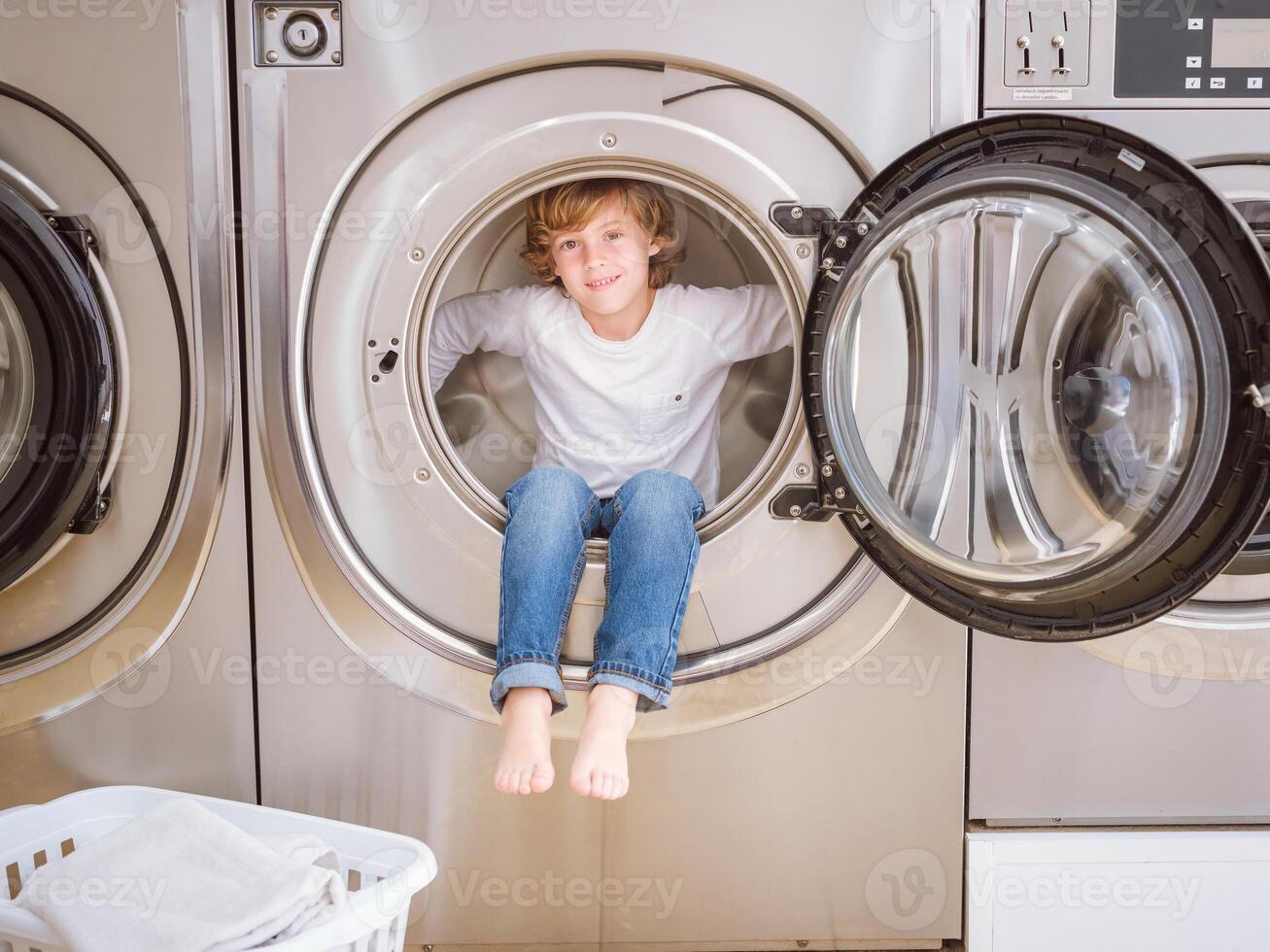 Joyful boy in washing machine photo