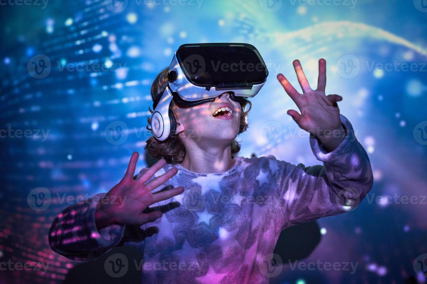 Surprised little boy discovering cyberspace in VR headset photo