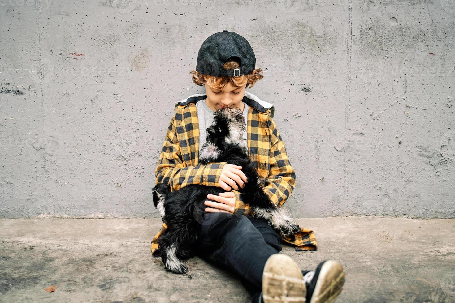 Little boy with purebred dog on street photo
