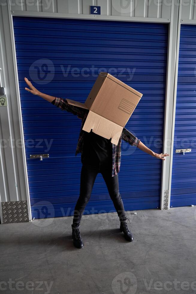 Faceless carefree person with box on head photo