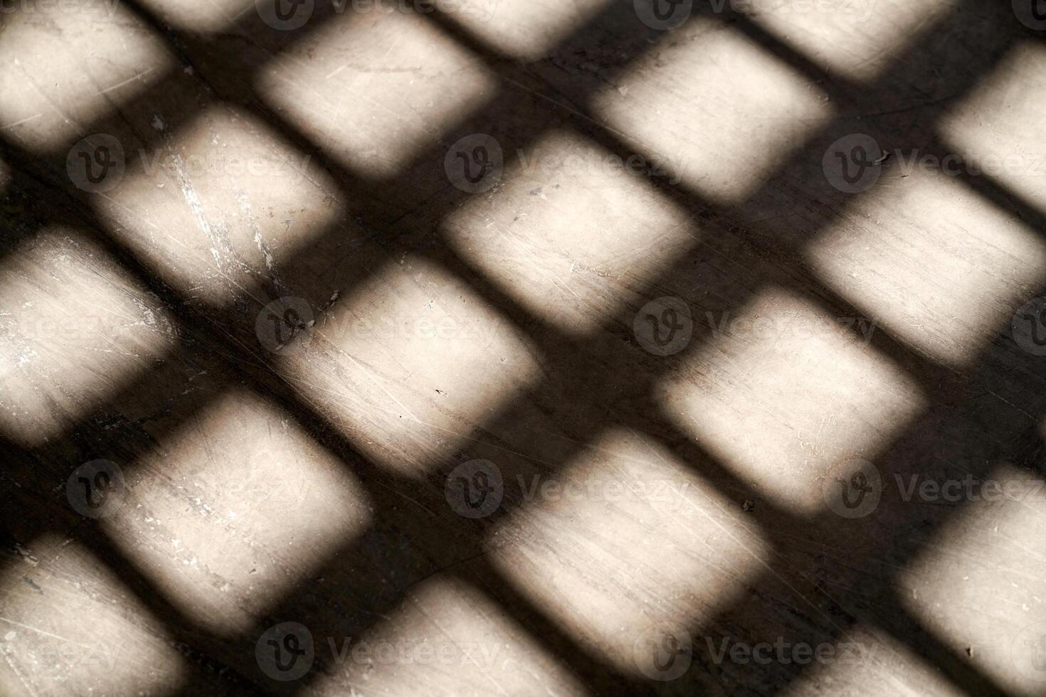 Shadow of window grid on floor in daylight photo