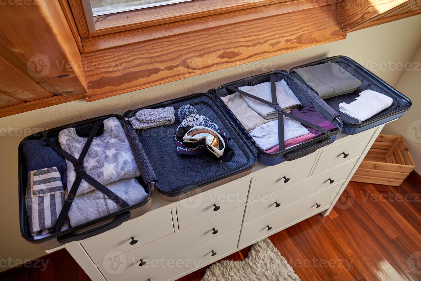 Open luggages on wooden cabinet photo