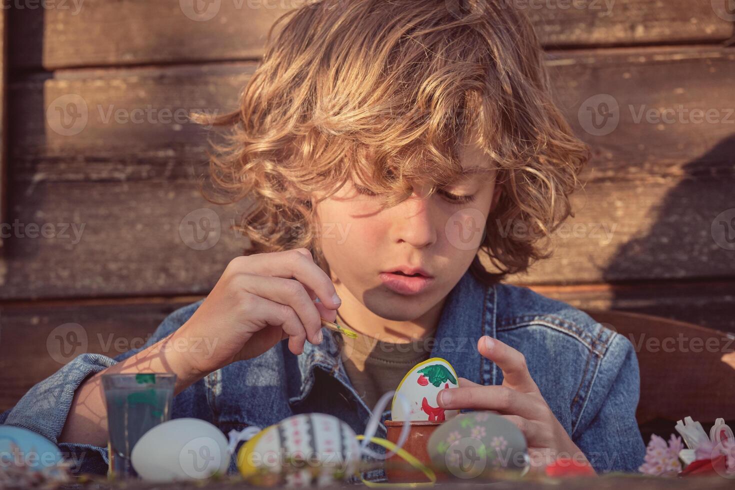 Concentrated boy with Easter eggs photo