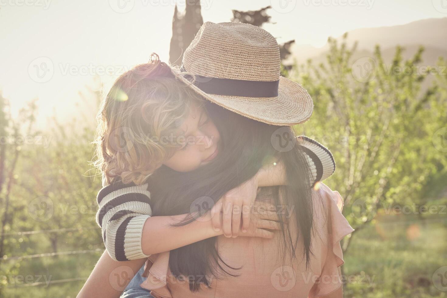 Little son with woman in field photo