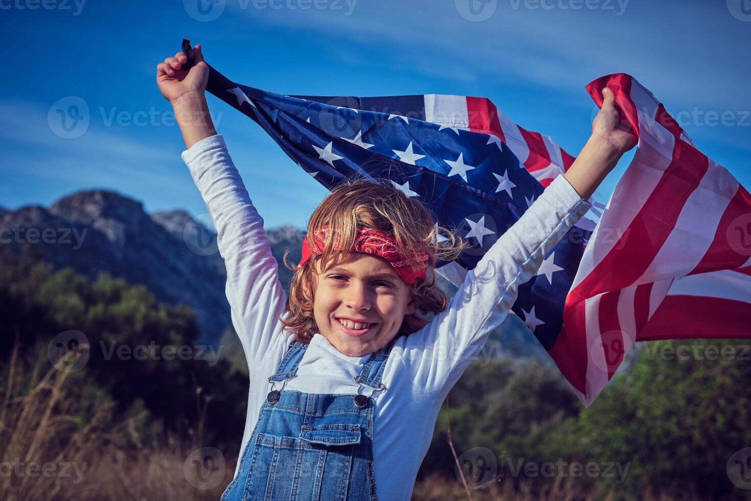 Happy preteen boy with waving American flag photo