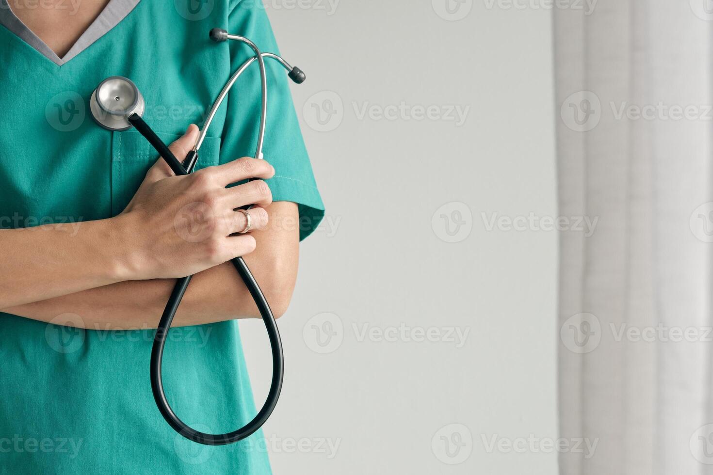 Faceless surgeon with crossed arms and stethoscope photo