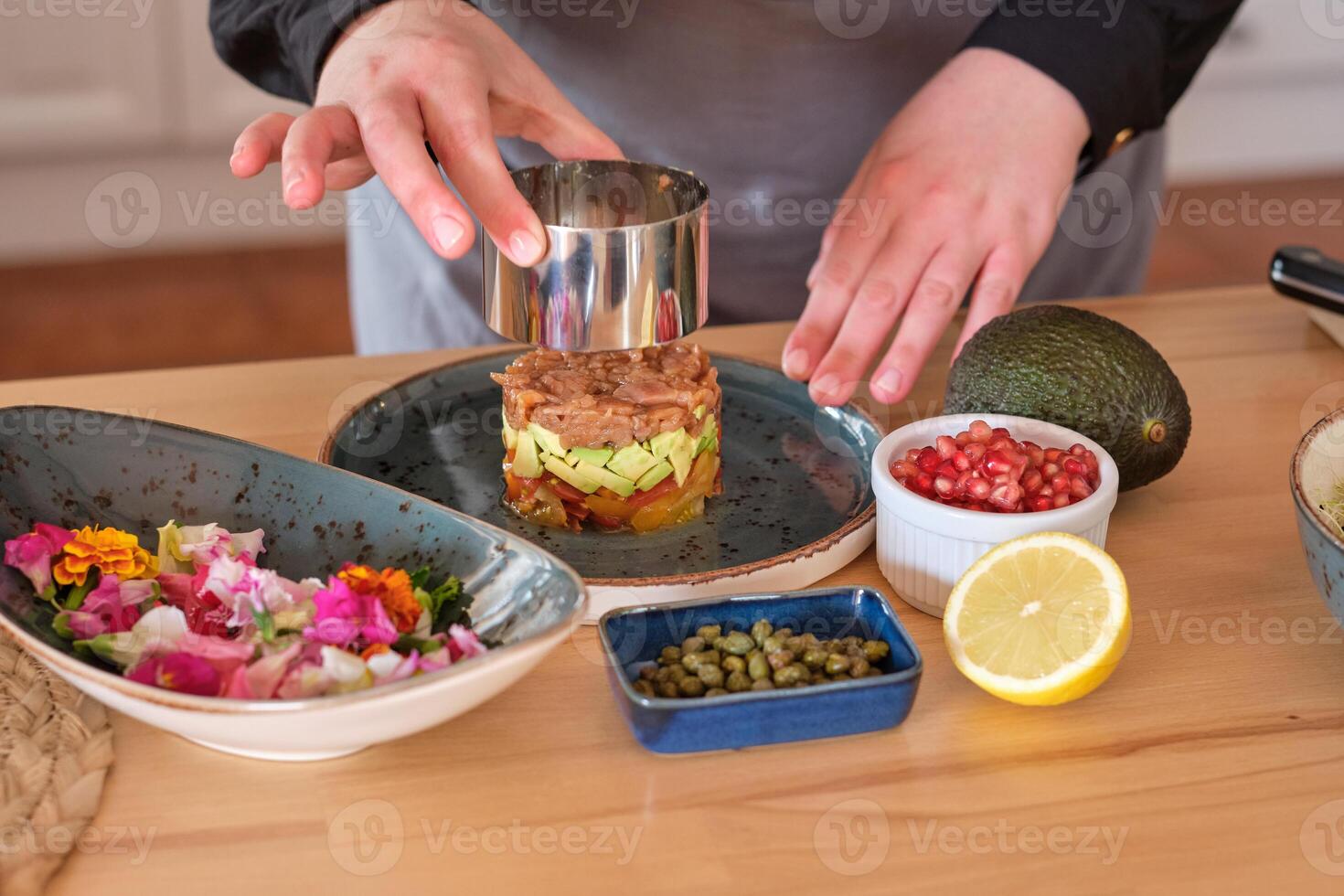 Cook preparing tartar in kitchen photo
