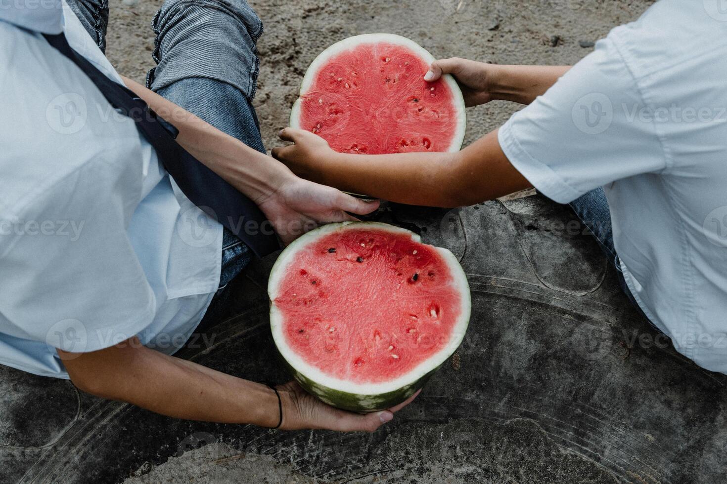 Crop kids carrying sliced watermelon with bare hands photo