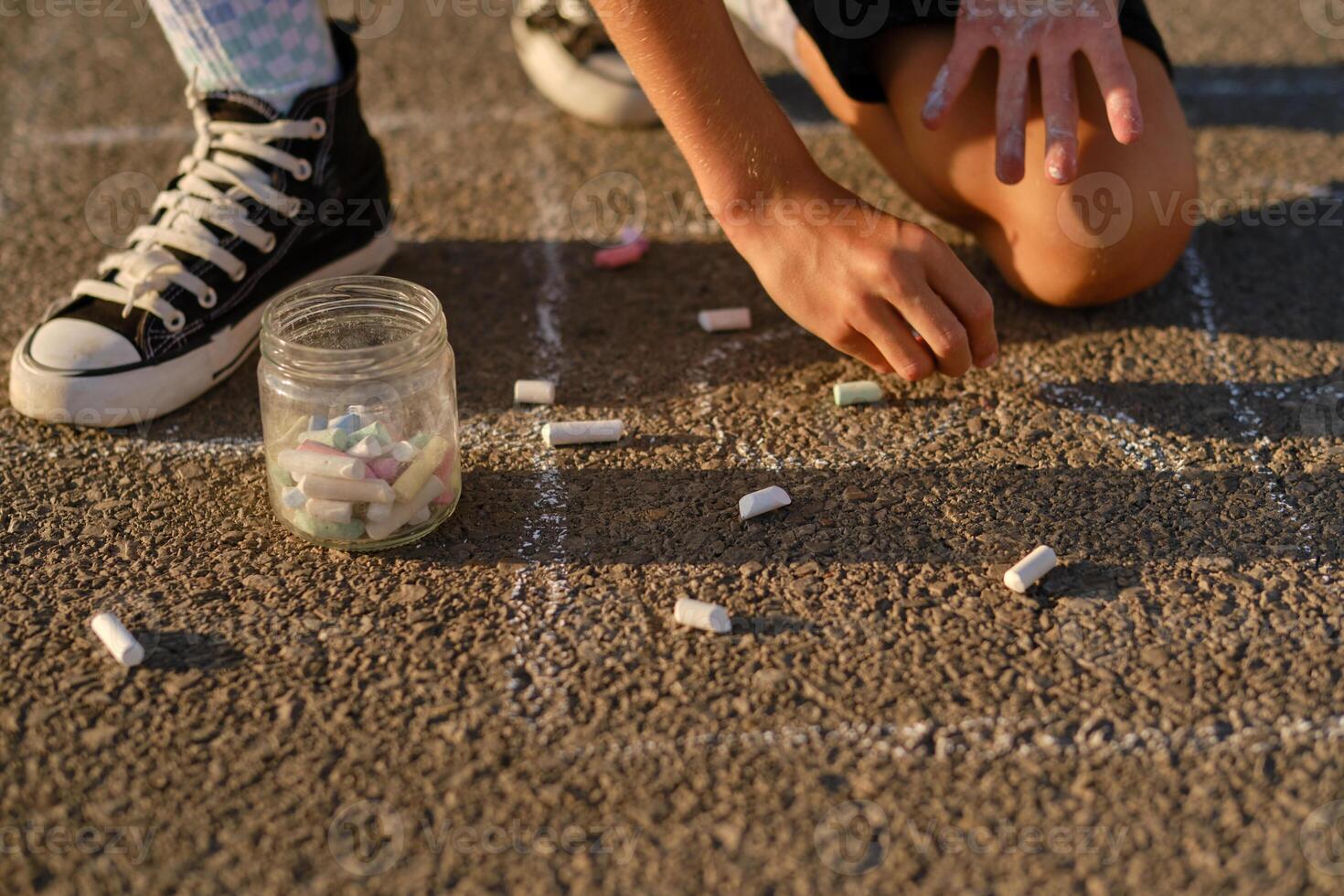 Crop child drawing on asphalt road photo