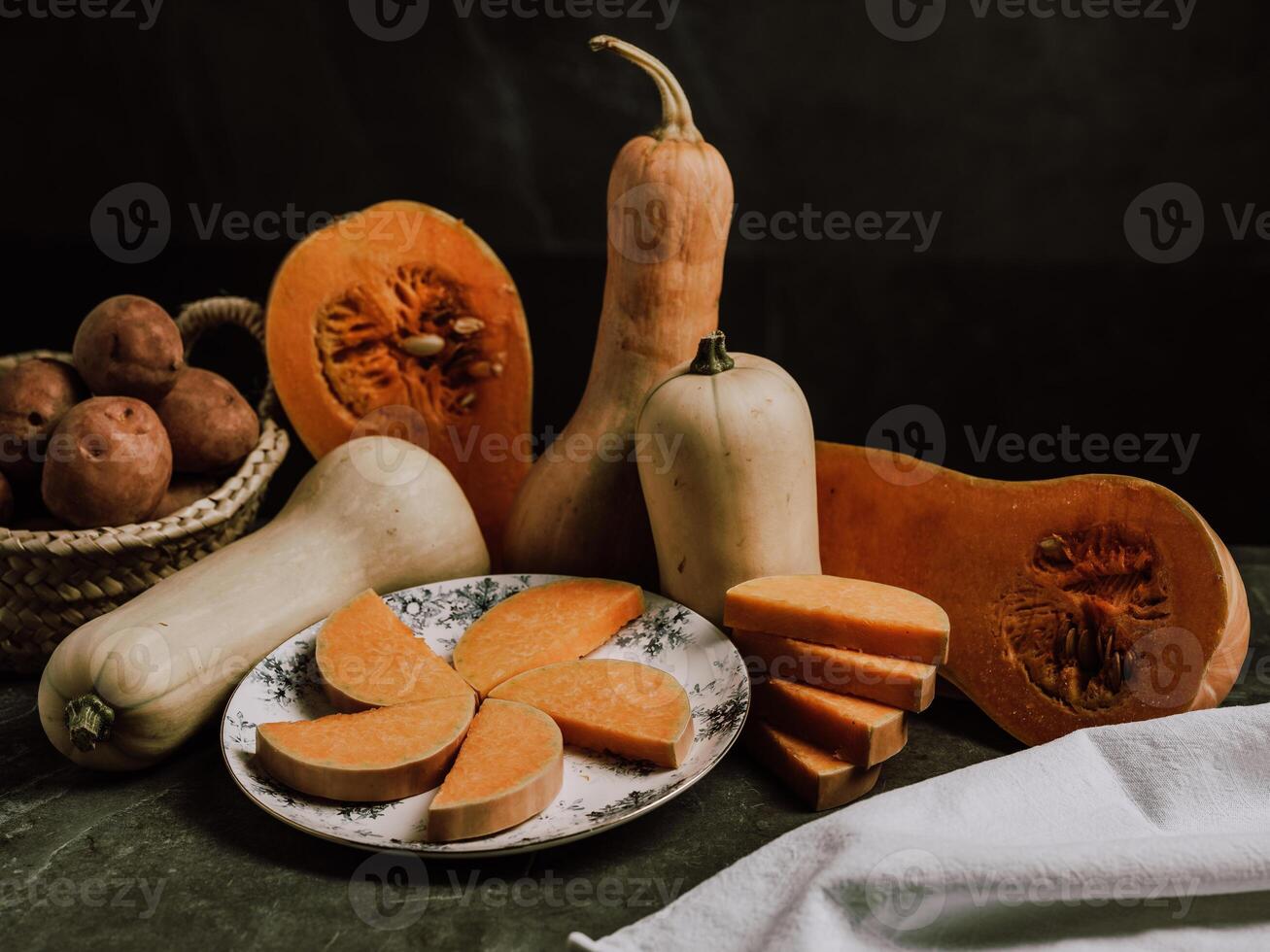 Still life of ripe nutmeg pumpkin and sliced butternut squash photo