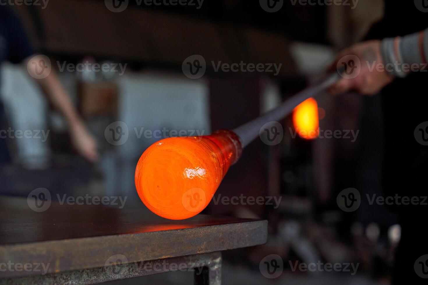 Crop worker forming vase in dark building photo